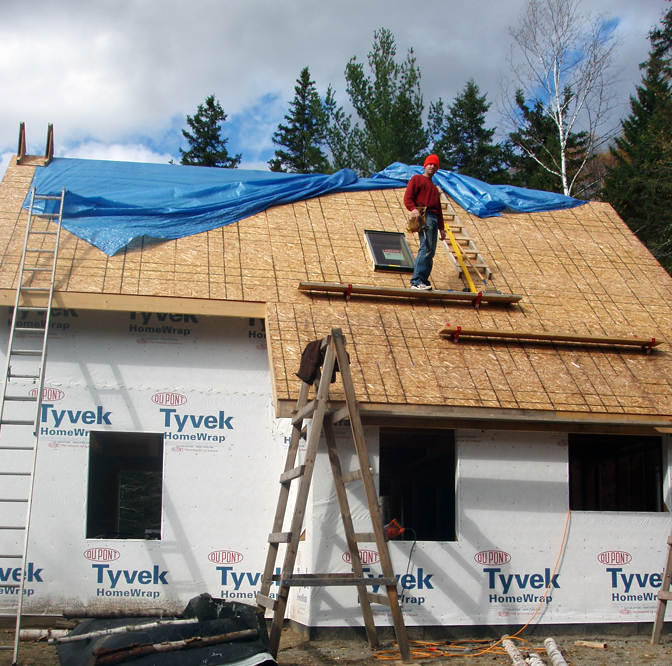 working on the steep pitch of the cottage roof
